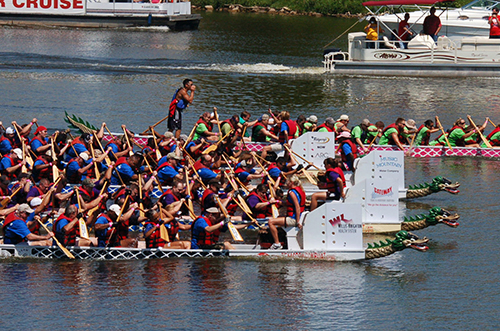 SHREVEPORT, La. – Members of the “Mighty Eighth” dragon boat team (second from top) battle for the lead against five other teams in the dragon boat races during the third annual Red River Dragon Boat Festival Sept. 10, 2011. This year's race featured 27 teams, all vigorously paddling 41-foot-long boats to the finish line. Each team is comprised of a minimum of 20 paddlers, a captain and a drummer who beats the cadence as they paddle. (U.S. Air Force photo by Staff Sgt. Brian Stives)