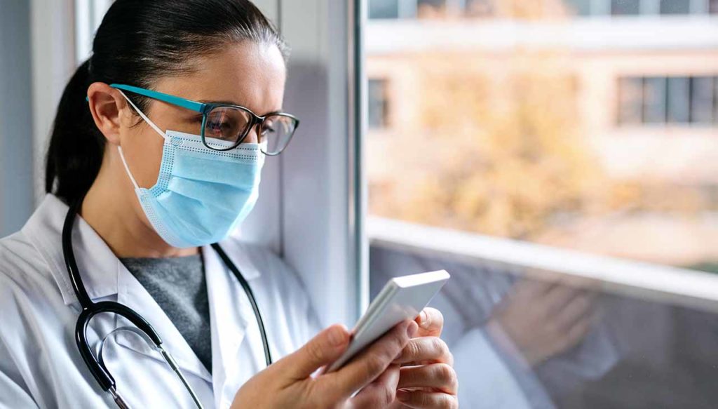Female doctor using smartphone | Healthcare Marketing